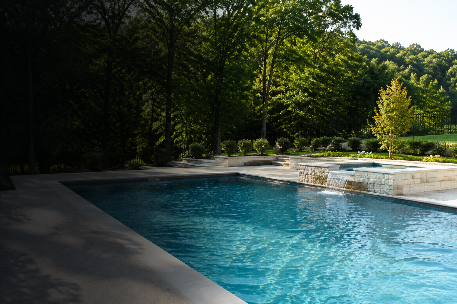 Renovated backyard swimming pool with raised spa and stone coping